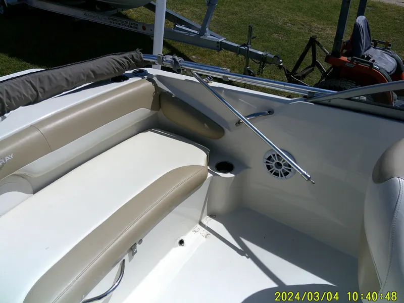 Slide: The Image of 2019 Stingray 191 Dual Console boat interior with beige seating and cup holder. - 24