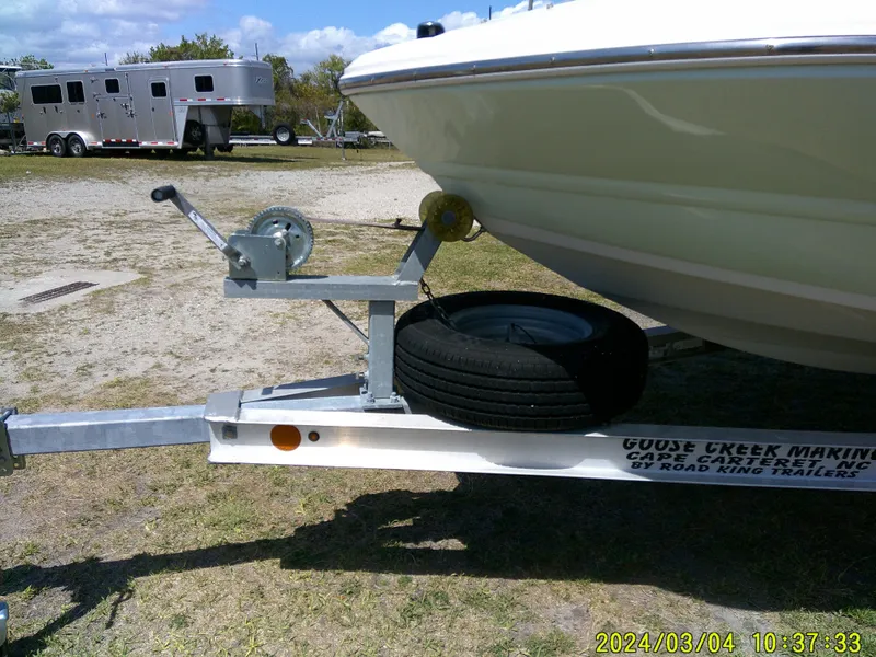 Slide: The Image of 2019 Stingray 191 Dual Console boat on trailer with spare tire, parked outdoors. - 5