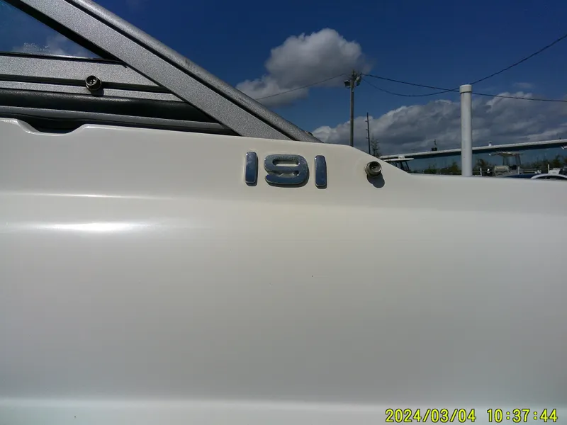 Slide: The Image of 2019 Stingray 191 Dual Console boat exterior with model number, under a clear blue sky. - 7