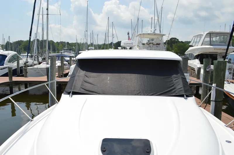 Slide: The Image of 2019 Tiara Yachts C39 Coupe docked at marina, front view with covered windshield. - 10