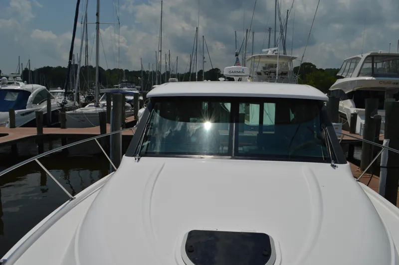 Slide: The Image of 2019 Tiara Yachts C39 Coupe docked at marina under cloudy sky. - 11