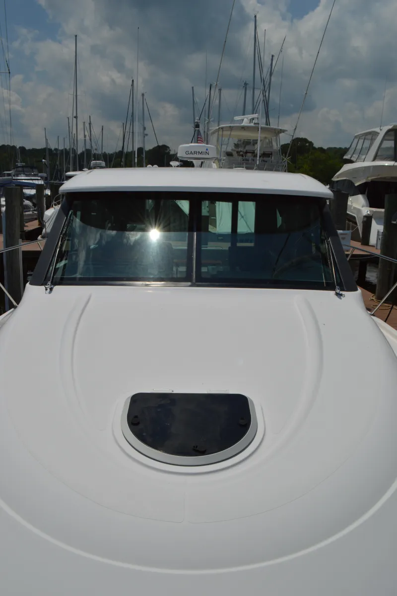 Slide: The Image of 2019 Tiara Yachts C39 Coupe docked, showcasing sleek design and modern features. - 12