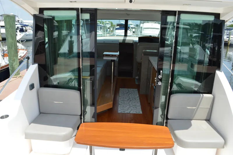 Slide: The Image of 2019 Tiara Yachts C39 Coupe interior with seating and table, docked at marina. - 20