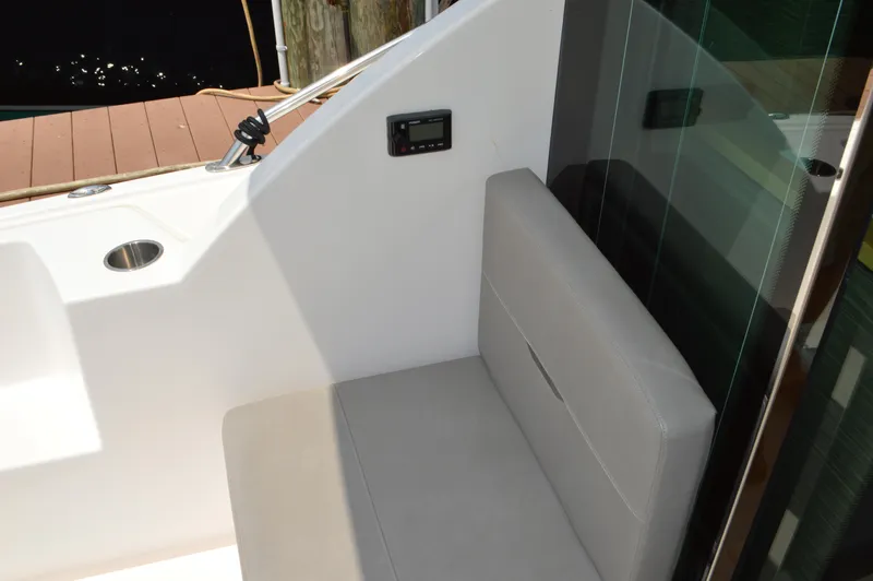 Slide: The Image of 2019 Tiara Yachts C39 Coupe interior seating area with control panel and cup holder. - 22