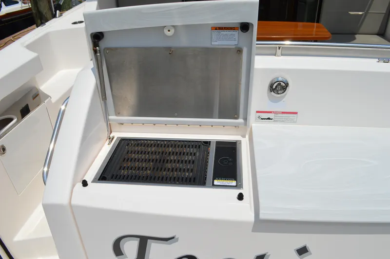 Slide: The Image of Outdoor grill on 2019 Tiara Yachts C39 Coupe deck, featuring stainless steel finish. - 23