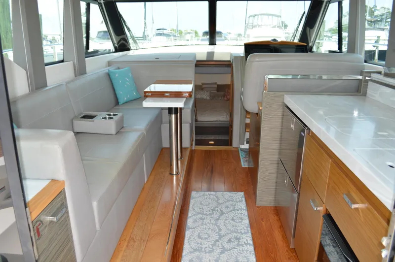 Slide: The Image of Interior of 2019 Tiara Yachts C39 Coupe, featuring modern seating and wooden flooring. - 28