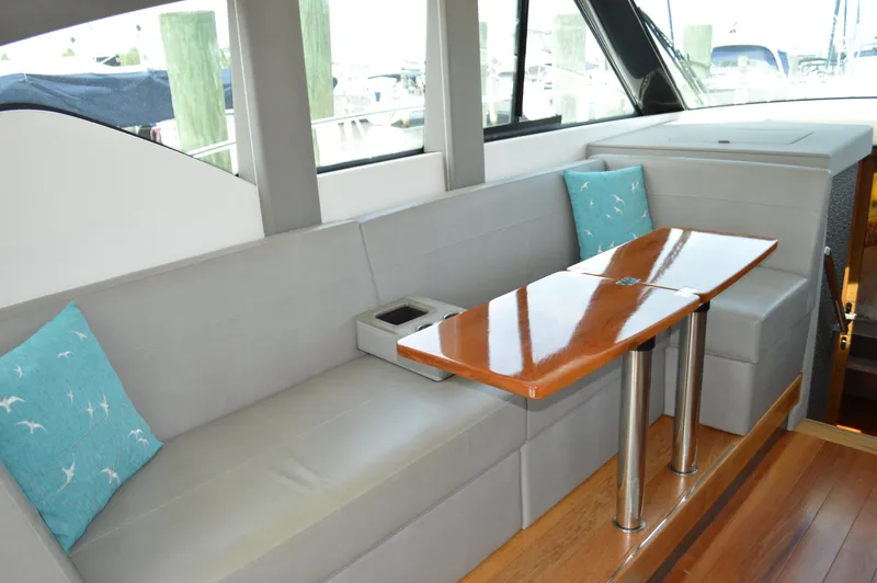 Slide: The Image of 2019 Tiara Yachts C39 Coupe interior with sleek seating and polished wooden table. - 30