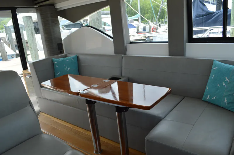 Slide: The Image of 2019 Tiara Yachts C39 Coupe interior with sleek seating and wooden table. - 31