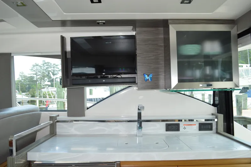Slide: The Image of Interior of 2019 Tiara Yachts C39 Coupe with modern kitchen and TV setup. - 35