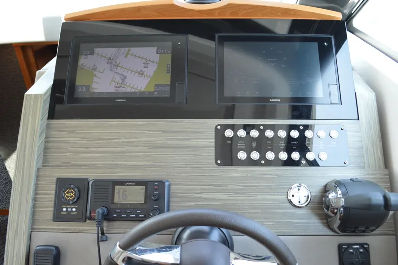 Slide: The Image of 2019 Tiara Yachts C39 Coupe helm with navigation screens and controls. - 38