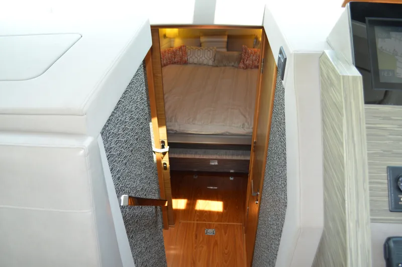 Slide: The Image of 2019 Tiara Yachts C39 Coupe cabin interior with bed and wooden flooring. - 40