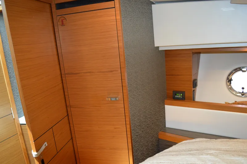 Slide: The Image of Interior cabin of 2019 Tiara Yachts C39 Coupe with wooden cabinetry and porthole. - 44