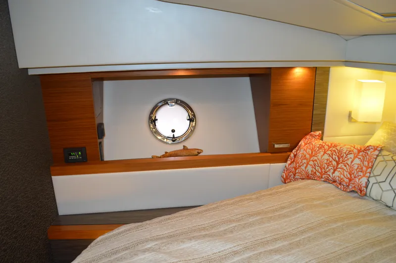 Slide: The Image of 2019 Tiara Yachts C39 Coupe interior with cozy bed and porthole window. - 45