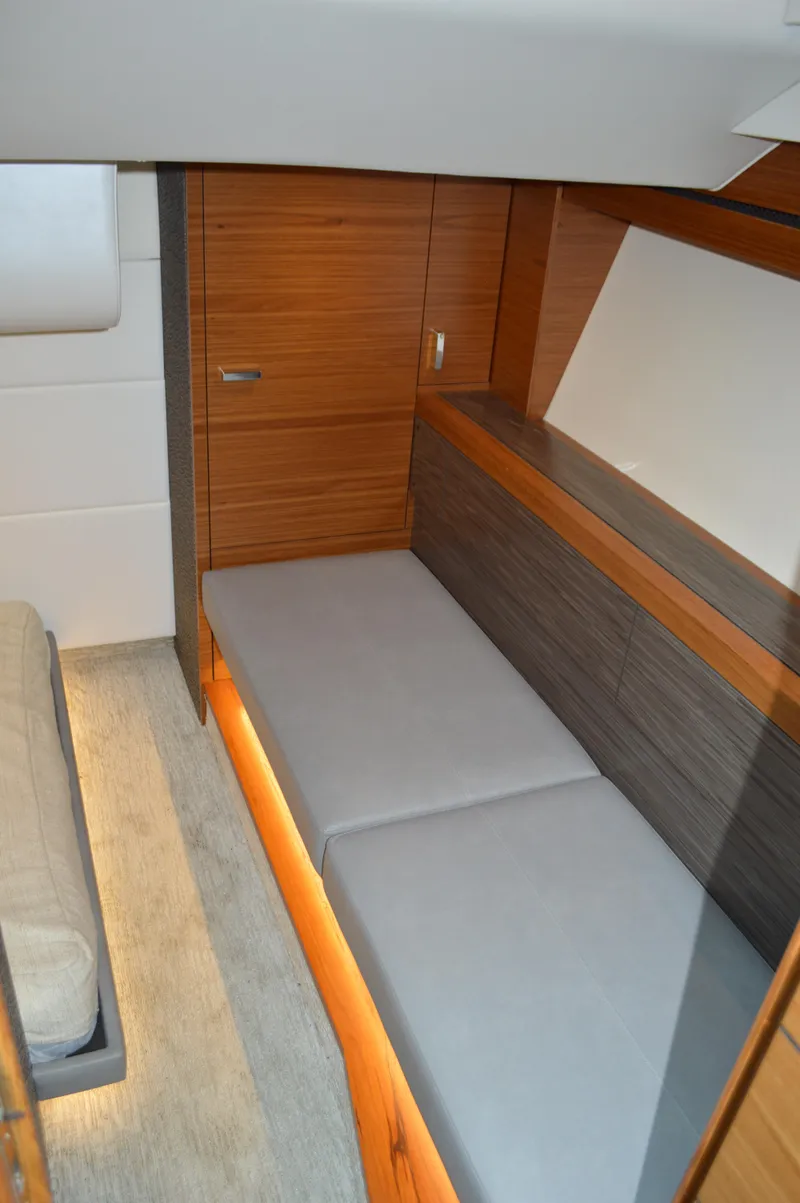 Slide: The Image of 2019 Tiara Yachts C39 Coupe interior cabin with modern wood finish and cozy seating. - 47