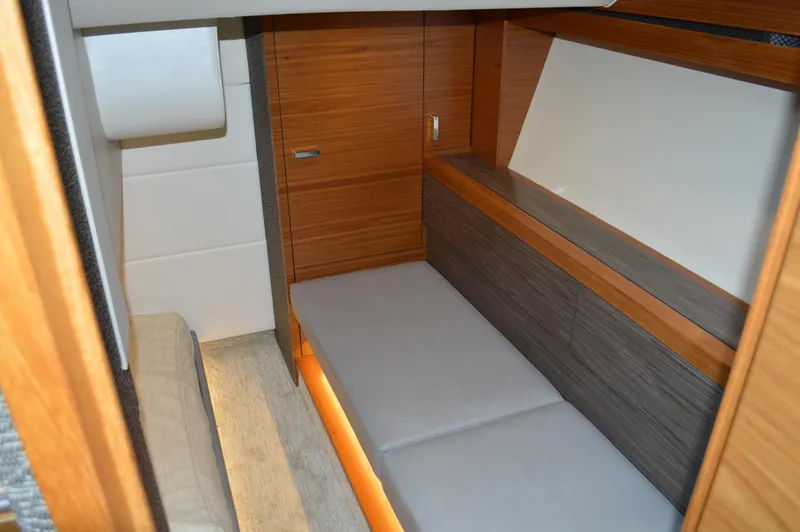 Slide: The Image of 2019 Tiara Yachts C39 Coupe interior cabin with modern wood finish and cozy seating. - 48