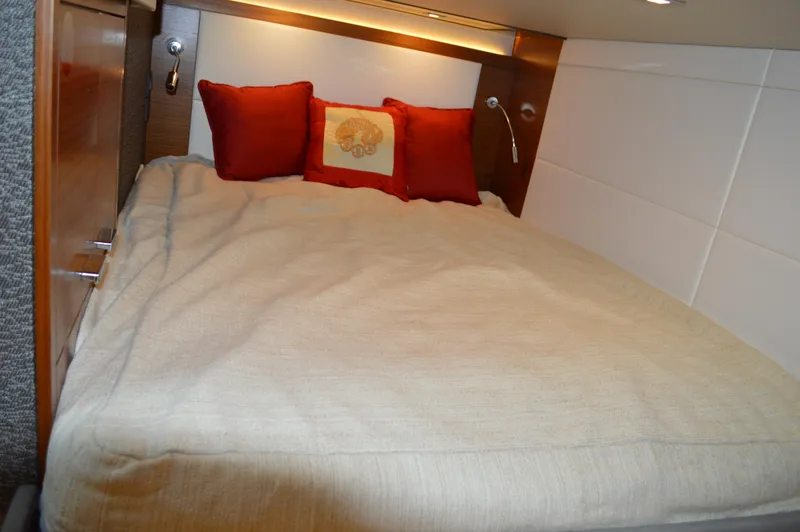 Slide: The Image of Cozy bedroom in 2019 Tiara Yachts C39 Coupe with red pillows and beige bedding. - 49