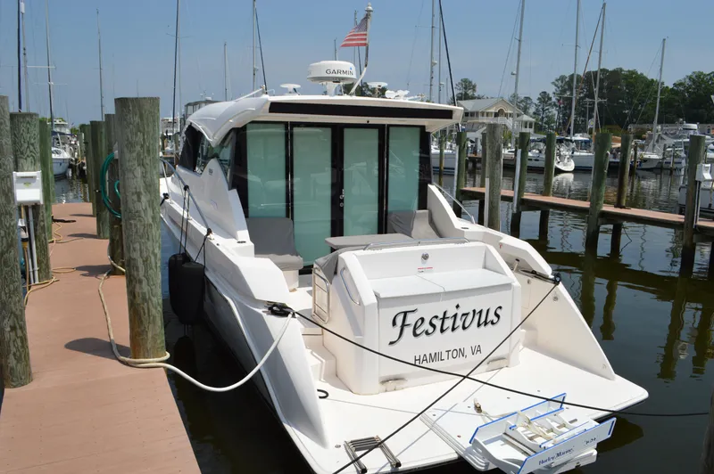 Slide: The Image of 2019 Tiara Yachts C39 Coupe docked, rear view, named "Festivus," in a marina setting. - 6