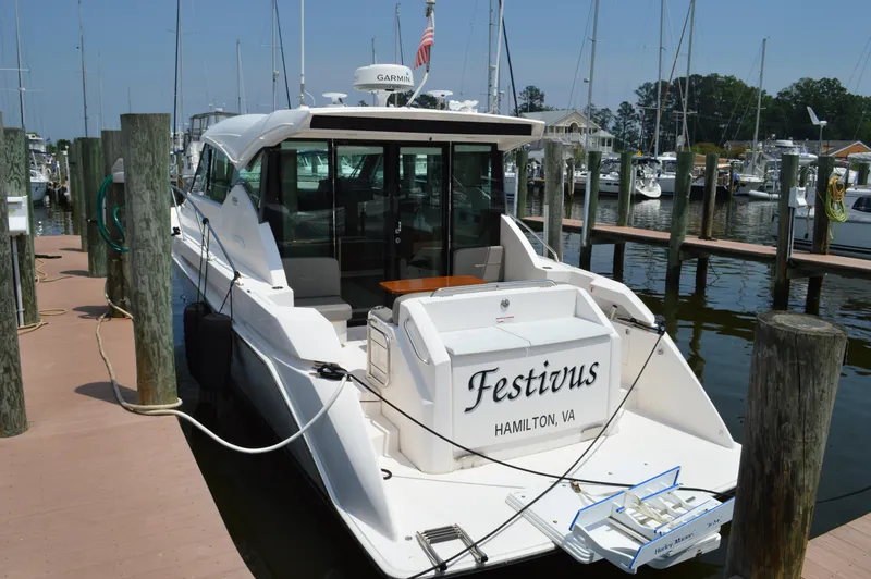 Slide: The Image of 2019 Tiara Yachts C39 Coupe docked, named "Festivus," in a marina setting. - 7