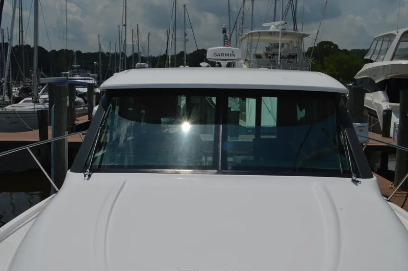 Slide: The Image of 2019 Tiara Yachts C39 Coupe docked at a marina, front view. - 9