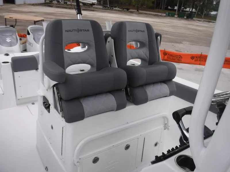 Slide: The Image of 2025 NauticStar 292 Legacy boat with dual Suzuki engines on the water. - 16
