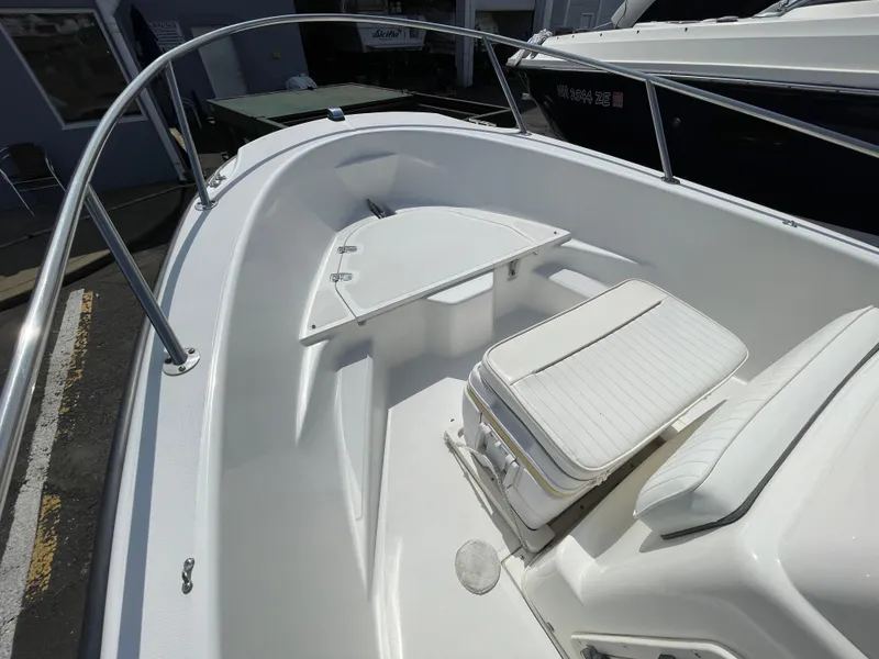 Slide: The Image of 1999 Boston Whaler 16 Dauntless boat interior with seating and storage. - 12