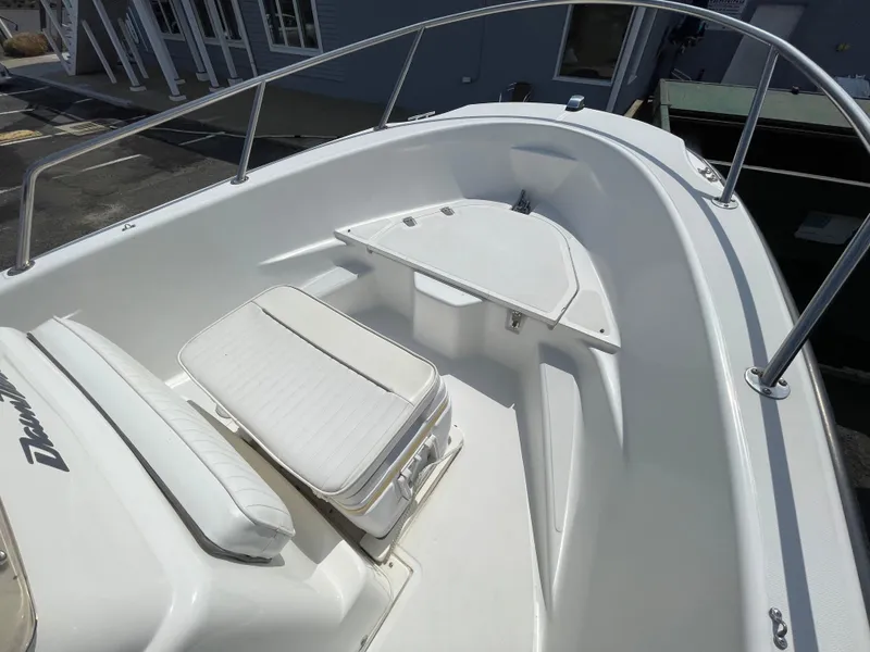 Slide: The Image of 1999 Boston Whaler 16 Dauntless boat interior with seating and storage compartments. - 13