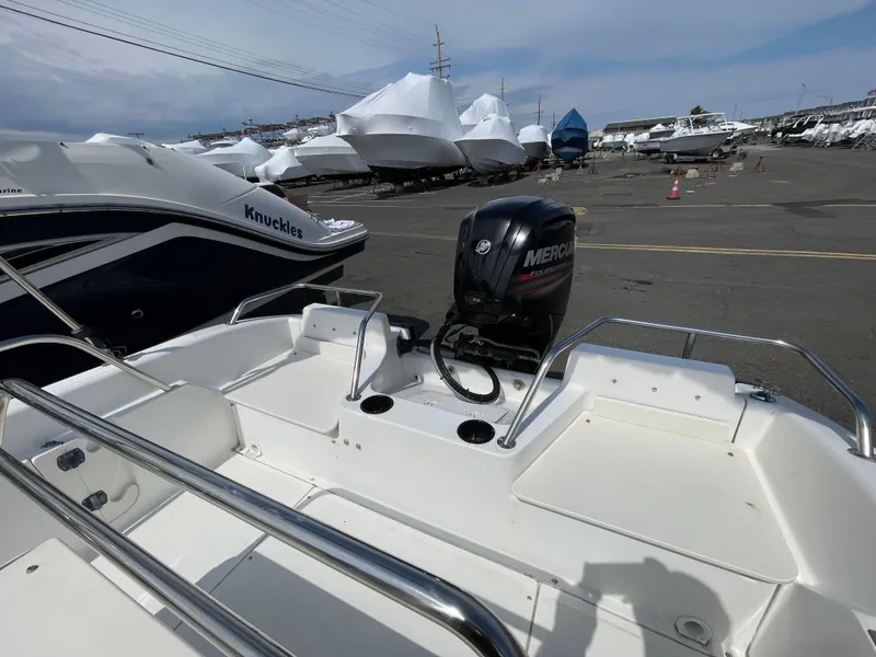 Slide: The Image of 1999 Boston Whaler 16 Dauntless boat with Mercury outboard motor in a marina. - 15