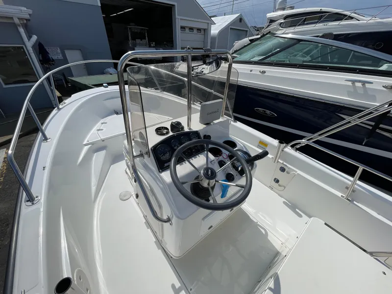 Slide: The Image of 1999 Boston Whaler 16 Dauntless boat interior with steering console and controls. - 7