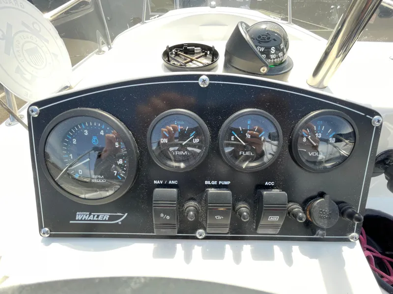 Slide: The Image of 1999 Boston Whaler 16 Dauntless dashboard with gauges and controls. - 9