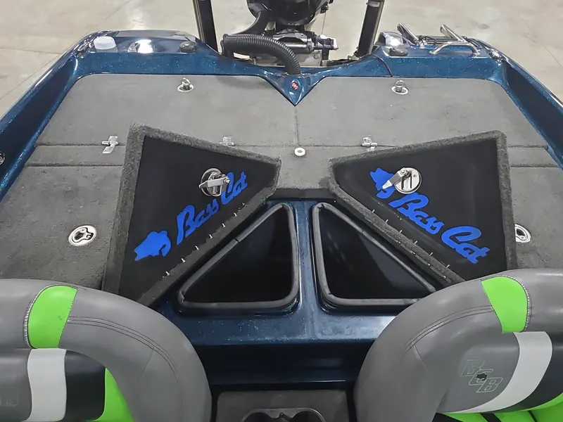 Slide: The Image of 2014 Bass Cat Eyra boat interior with open storage compartments and branded seats. - 11
