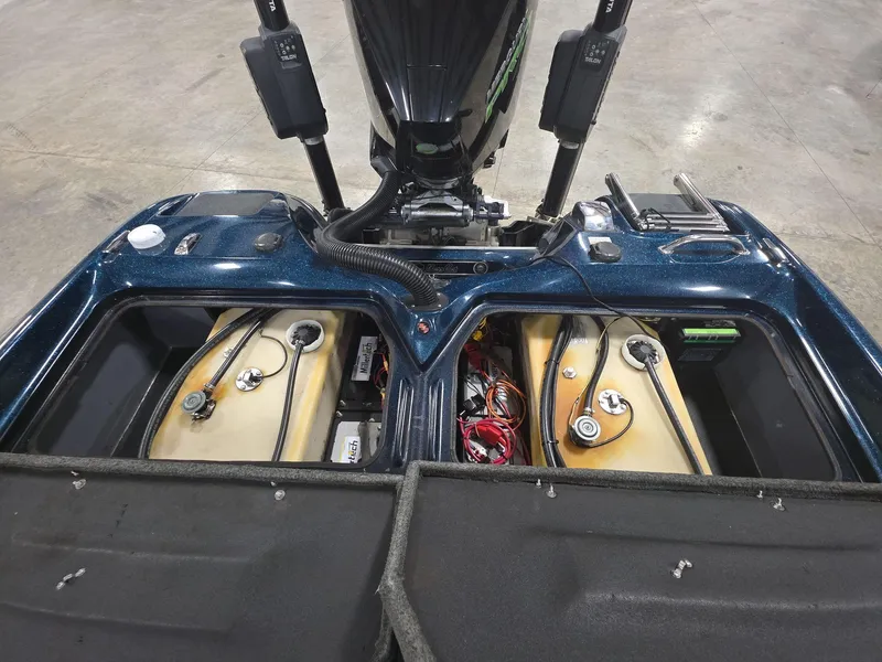 Slide: The Image of 2014 Bass Cat Eyra boat engine compartment with wiring and fuel tanks visible. - 15