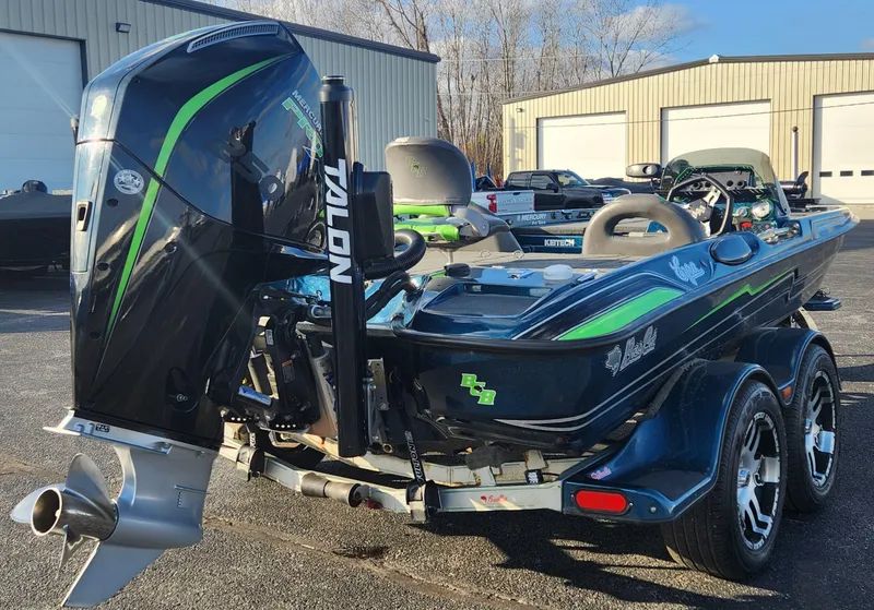 Slide: The Image of 2014 Bass Cat Eyra boat with powerful outboard motor, parked outdoors. - 18