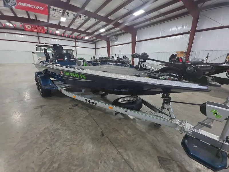 Slide: The Image of 2014 Bass Cat Eyra boat on trailer in indoor showroom. - 2