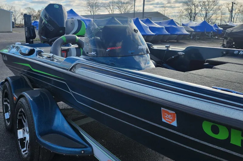 Slide: The Image of 2014 Bass Cat Eyra boat with sleek design and powerful engine, parked outdoors. - 20