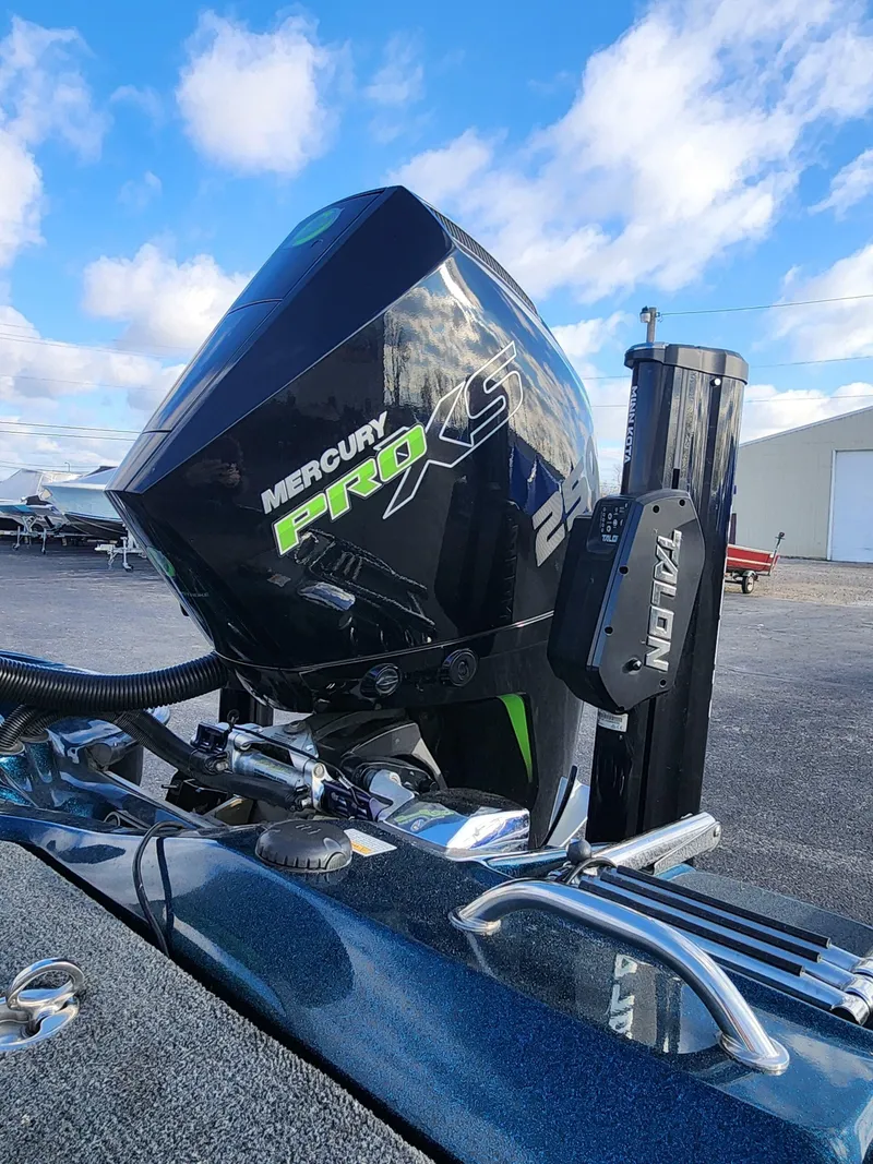 Slide: The Image of 2014 Bass Cat Eyra with Mercury Pro XS engine, parked outdoors under a blue sky. - 22