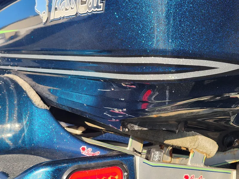 Slide: The Image of 2014 Bass Cat Eyra boat with metallic blue finish and sleek design details. - 25