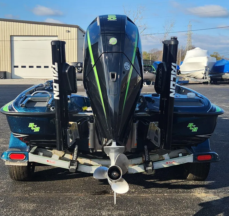 Slide: The Image of 2014 Bass Cat Eyra boat on trailer, featuring Talon anchors and powerful outboard motor. - 26