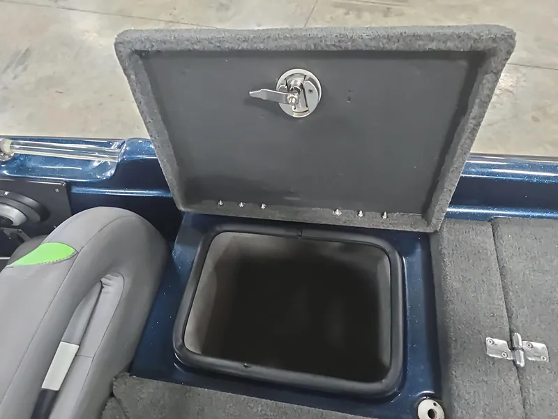 Slide: The Image of 2014 Bass Cat Eyra boat storage compartment with open lid, showcasing interior space. - 33