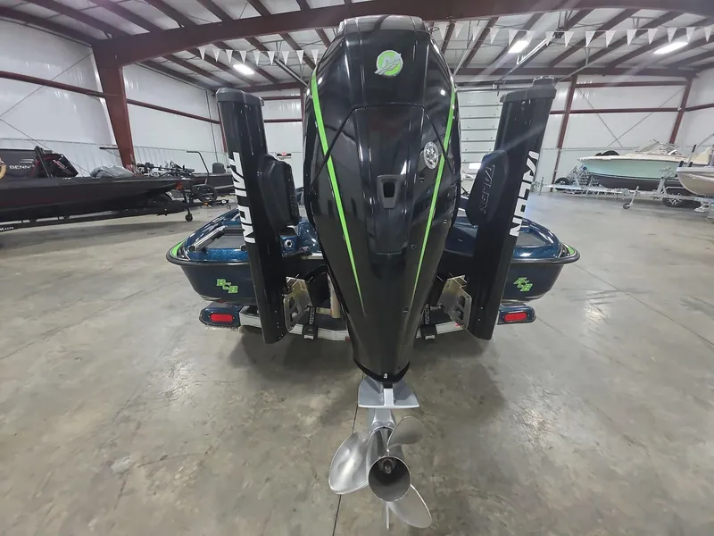Slide: The Image of 2014 Bass Cat Eyra boat in warehouse, rear view with motor and Talon anchors. - 4