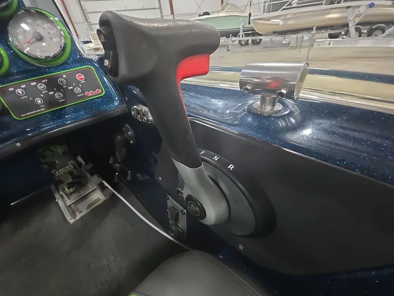 Slide: The Image of 2014 Bass Cat Eyra boat interior with control panel and throttle lever. - 8