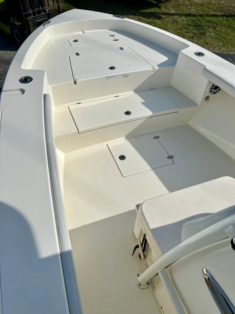 Slide: The Image of 2024 Pathfinder 2700 Open boat interior with storage compartments and seating. - 26