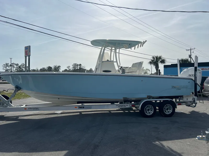 Slide: The Image of 2024 Pathfinder 2700 Open boat on trailer, light blue hull, parked outdoors. - 28