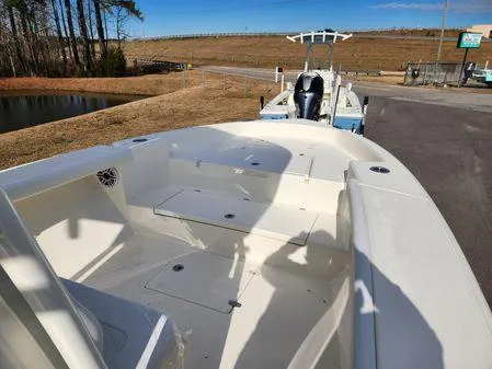 Slide: The Image of 2024 Pathfinder 2700 Open boat on trailer, parked near a pond and grassy area. - 5