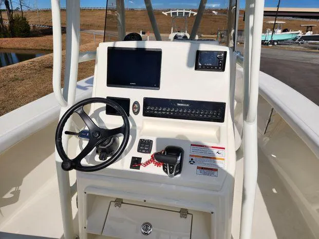 Slide: The Image of 2024 Pathfinder 2700 Open boat console with steering wheel and navigation controls. - 8