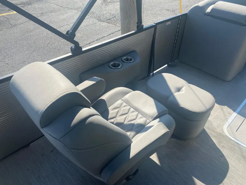 Slide: The Image of 2022 Bennington LX 24 Swingback interior with gray seating and cup holders. - 10