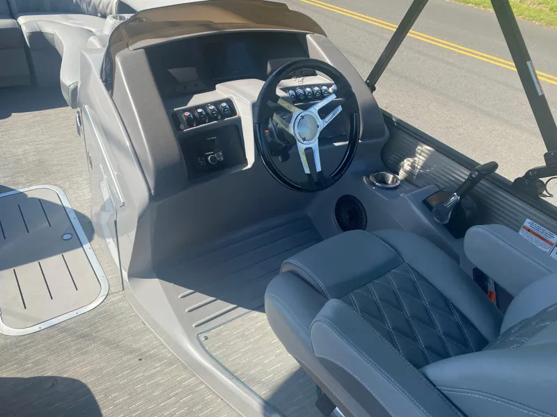 Slide: The Image of 2022 Bennington LX 24 Swingback boat interior with steering wheel and seating. - 11