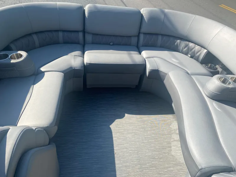 Slide: The Image of Luxurious seating on 2022 Bennington LX 24 Swingback pontoon boat, featuring plush gray upholstery. - 14