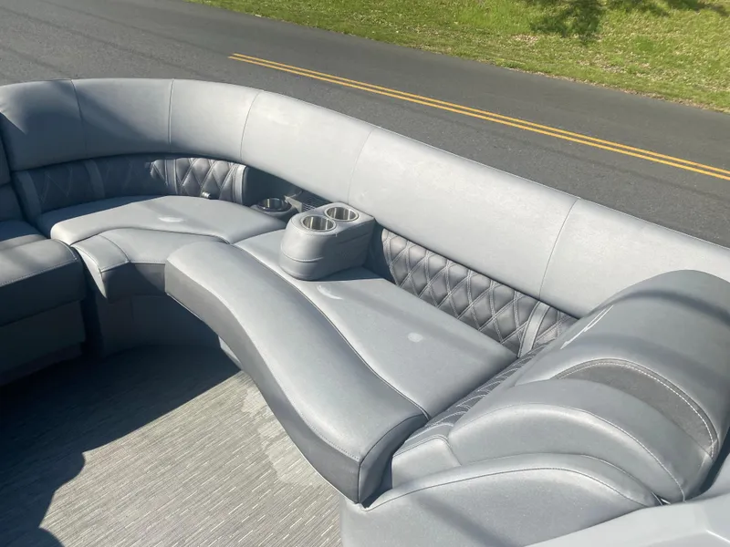 Slide: The Image of 2022 Bennington LX 24 Swingback boat interior with gray seating and cup holders. - 15
