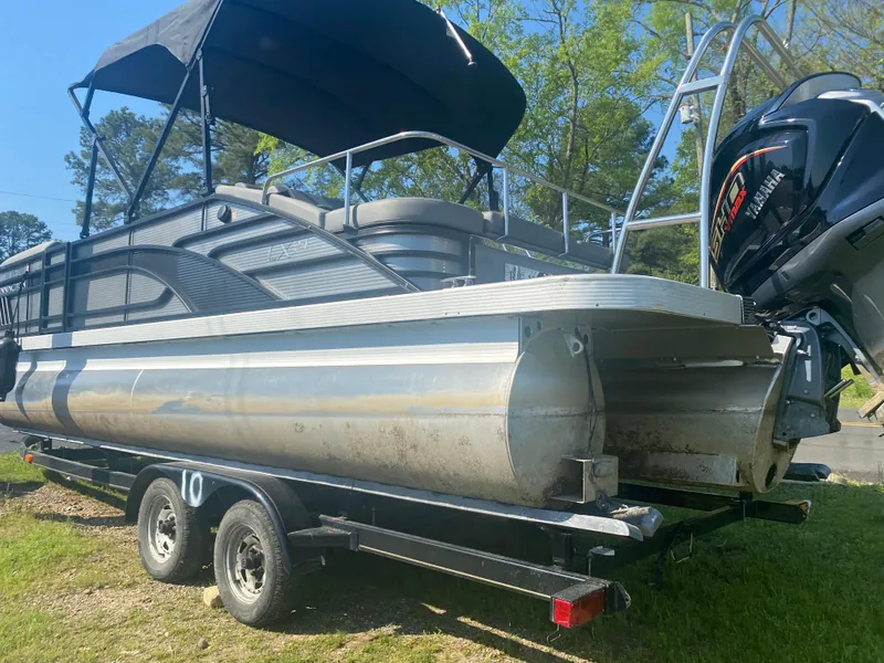 Slide: The Image of 2022 Bennington LX 24 Swingback pontoon boat on trailer, with canopy and outboard motor. - 3