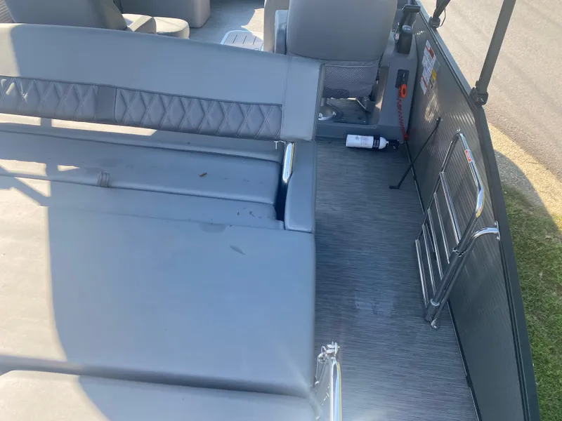 Slide: The Image of 2022 Bennington LX 24 Swingback interior with gray seating and flooring. - 7